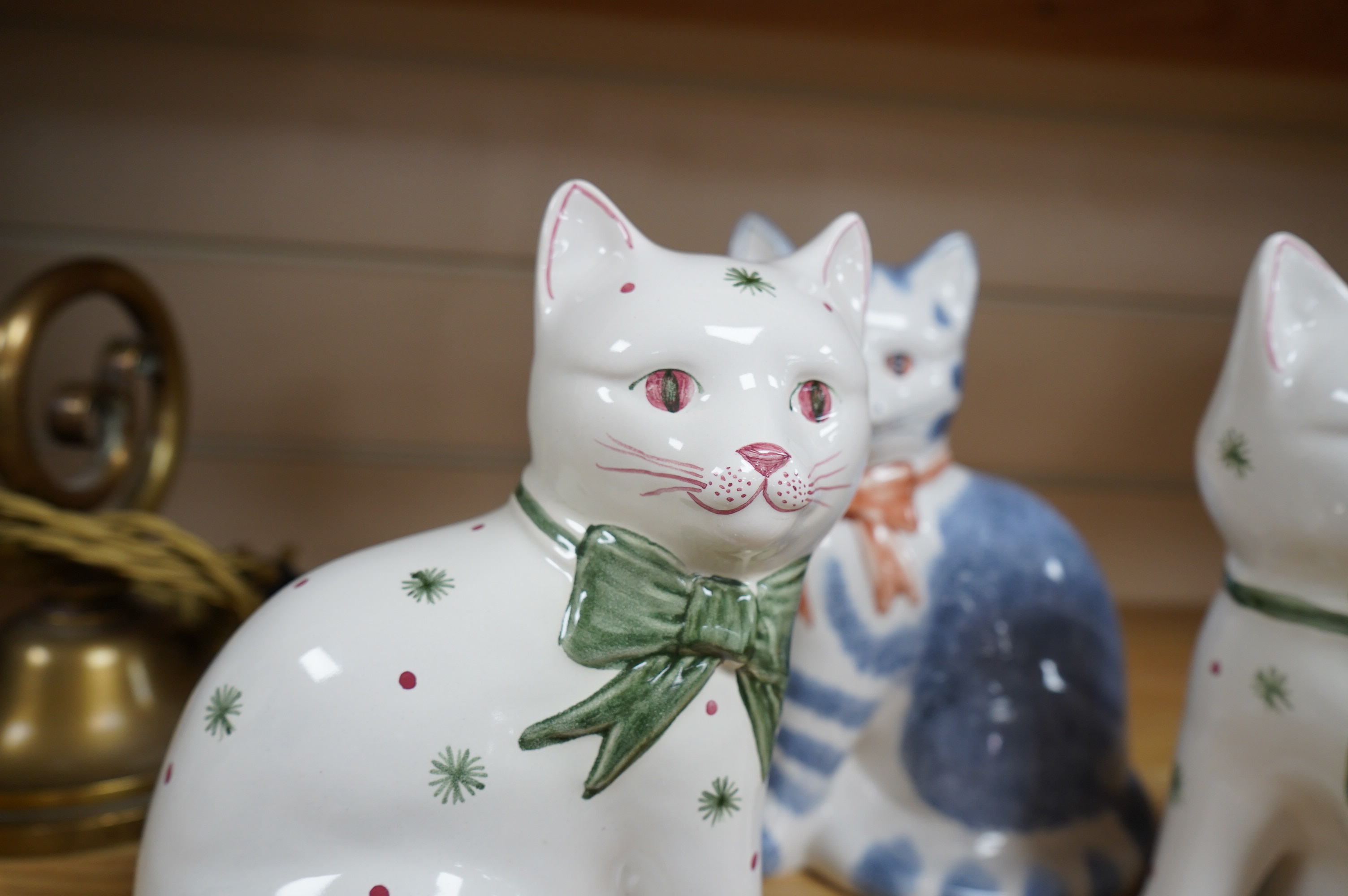 A pair of Rye pottery seated cats, and another, largest 19.5cm high. Condition - good